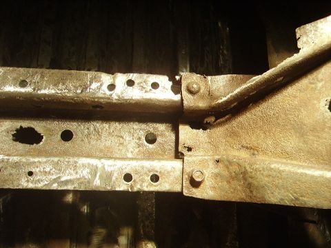 1978 Ford Bronco - This image shows heavily rusted metal frame components, likely from a vehicle's undercarriage.