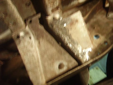 1978 Ford Bronco - Close-up view of the vehicle's undercarriage, focusing on structural and suspension elements.