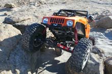 1990 Ford Bronco - Remote control rock crawler vehicle tackling a challenging, rocky obstacle course.