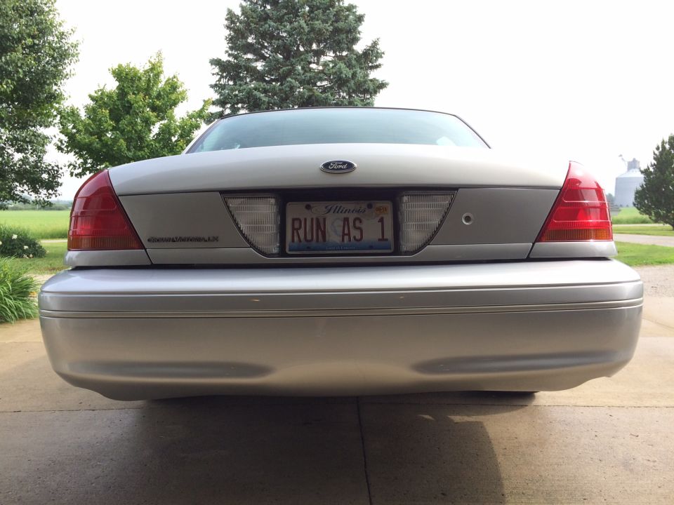 Rear view of a silver Ford Crown Victoria with Illinois license plate "RUN AS 1"