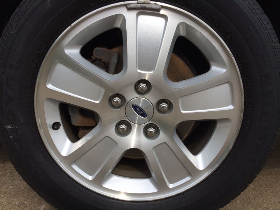 Silver five-spoke alloy wheel with Ford logo on a black tire.