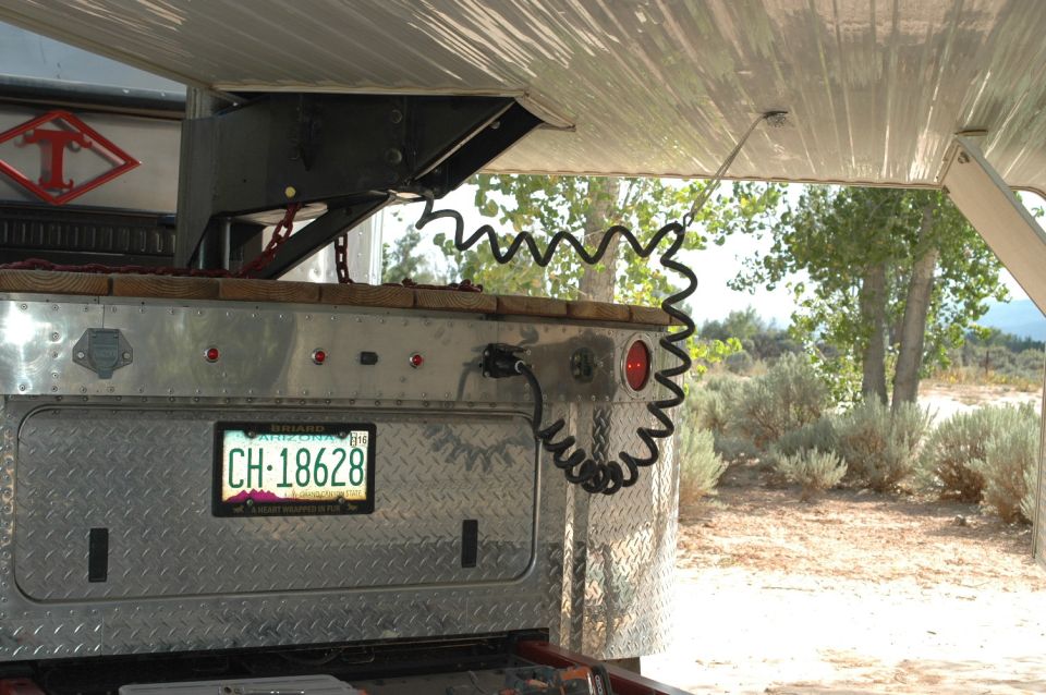 Trailer rear with coiled electrical cord and Arizona license plate CH-18628.
