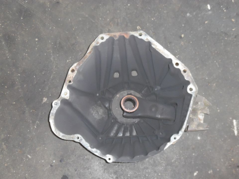 transmission bell housing with mounting holes and a central bearing race