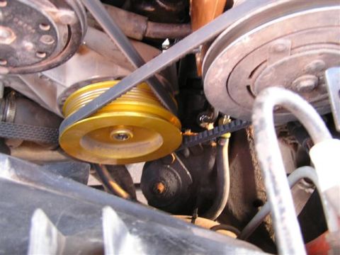 1994 Ford Bronco - Close-up of an engine's belt system, showing pulleys and belts.