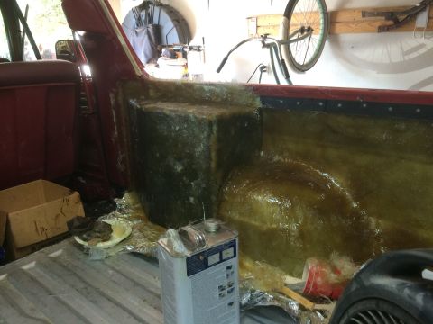 1979 Ford Bronco - The interior of a vehicle is being modified with fiberglass. A large, custom-molded fiberglass enclosure is being built into the rear cargo…