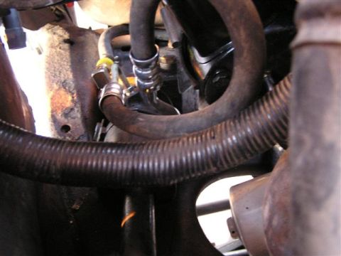 1994 Ford Bronco - Engine bay detail showing various hoses and mechanical parts, with a Supermotors watermark.