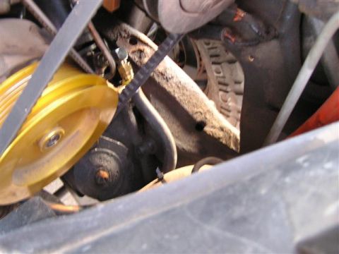 1994 Ford Bronco - This is a close-up view of the engine's belt and pulley system, showing mechanical components.