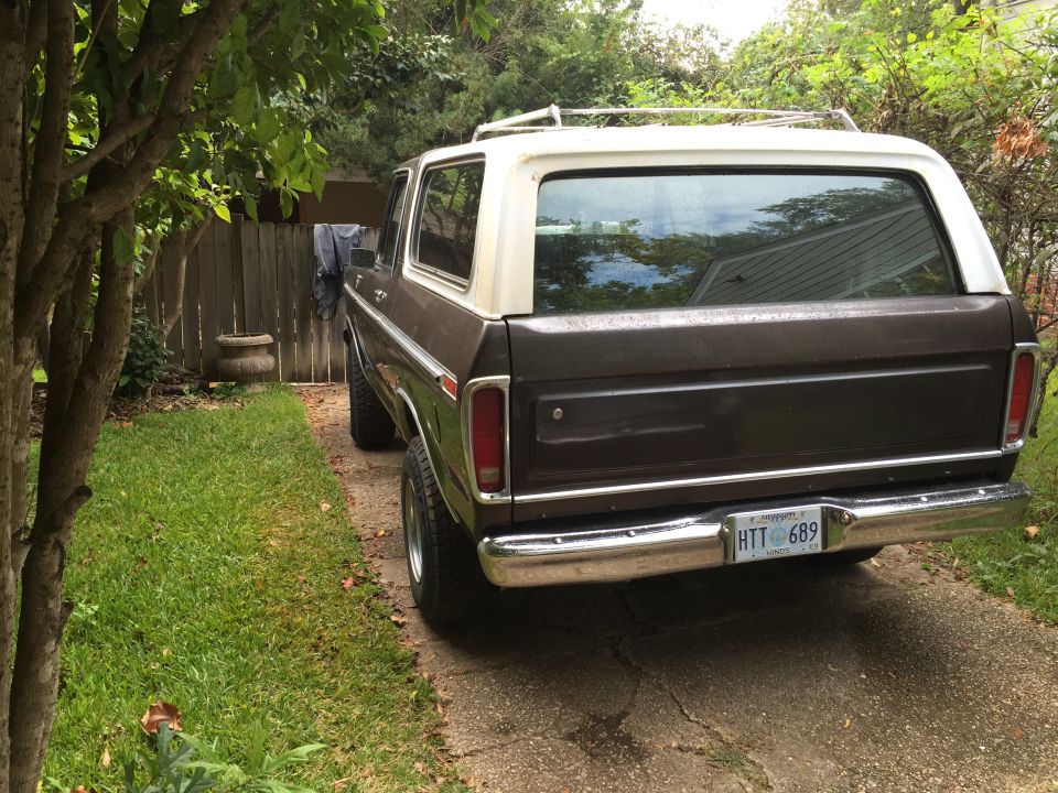 1978 Ford Bronco rear driver's side view, brown with white roof, parked on driveway.