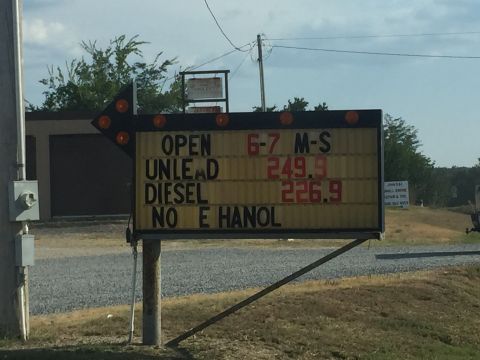 1993 Ford Bronco - A sign displays gas prices and operating hours for a business. The sign indicates that unleaded gas is $249.9 and diesel is $226.9, and the…