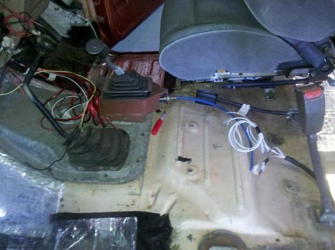 1982 Ford Bronco - The interior of a vehicle is shown with exposed wiring and insulation, indicating a rebuild or repair process.