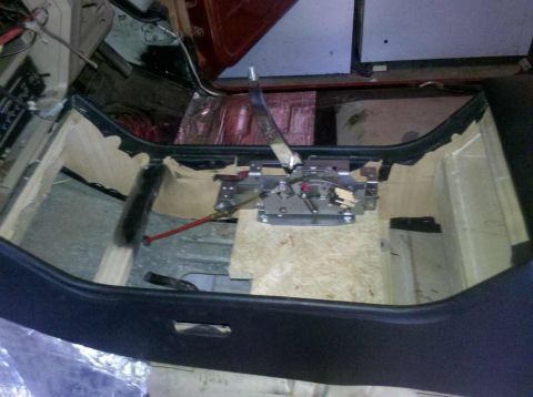1982 Ford Bronco - Vehicle interior showing the transmission shifter mechanism and floor, with sound deadening material installed.