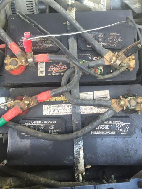 1993 Ford Bronco - Close-up view of two Interstate car batteries, showing their terminals and wiring.
