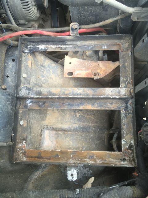 1993 Ford Bronco - The battery tray shows significant rust and wear, indicating it is a part needing attention.