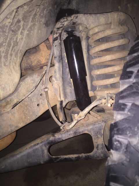 1993 Ford Bronco - Close-up of the rear suspension system on a 1993 Ford Bronco, showing the shock absorber and coil spring.