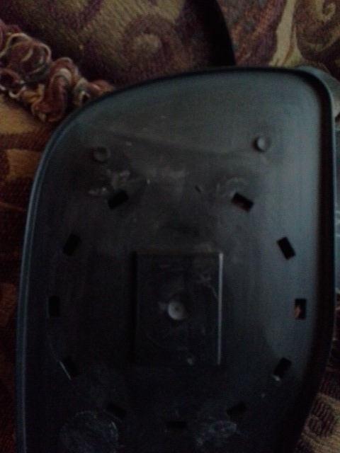 1993 Ford Bronco - The rear of a black car side mirror is shown, revealing its mounting points and attachment mechanism.
