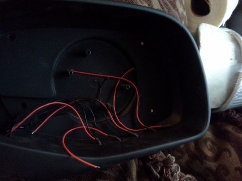 1993 Ford Bronco - Car mirror housing with wiring exposed, possibly for modification or repair.