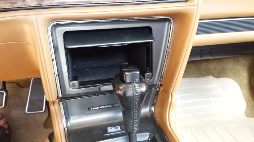 1991 Buick Reatta interior center console showing gear shifter and storage compartment