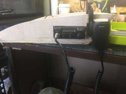 1993 Ford Bronco - A Cobra CB radio and microphone are mounted on a wooden panel, likely part of a custom installation. The panel has pencil markings and appe…