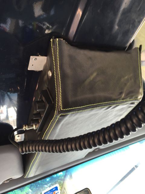 1993 Ford Bronco - A custom black leather CB radio mount with yellow stitching is attached to the dark blue interior headliner of a 1993 Ford Bronco. A coiled…