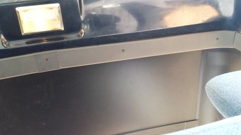 1993 Ford Bronco - A close-up view of the interior of a vehicle, showing a light fixture and a gray trim piece with visible screws. The background is dark and…
