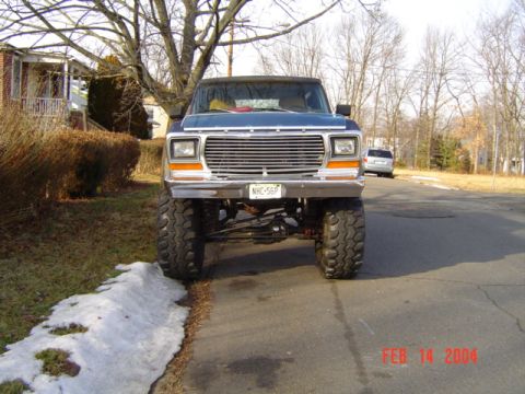 1994 Ford Bronco - This lifted pickup truck features a prominent chrome grille and large off-road tires, suggesting a model from the late 1970s.