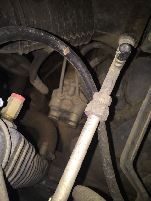 1993 Ford Bronco - This is a close-up view of engine components, including various hoses, metal lines, and a valve assembly, likely from a 1993 Ford Bronco.