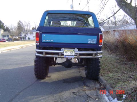 1994 Ford Bronco - Blue Ford Bronco modified with off-road tires and a heavy-duty rear bumper.