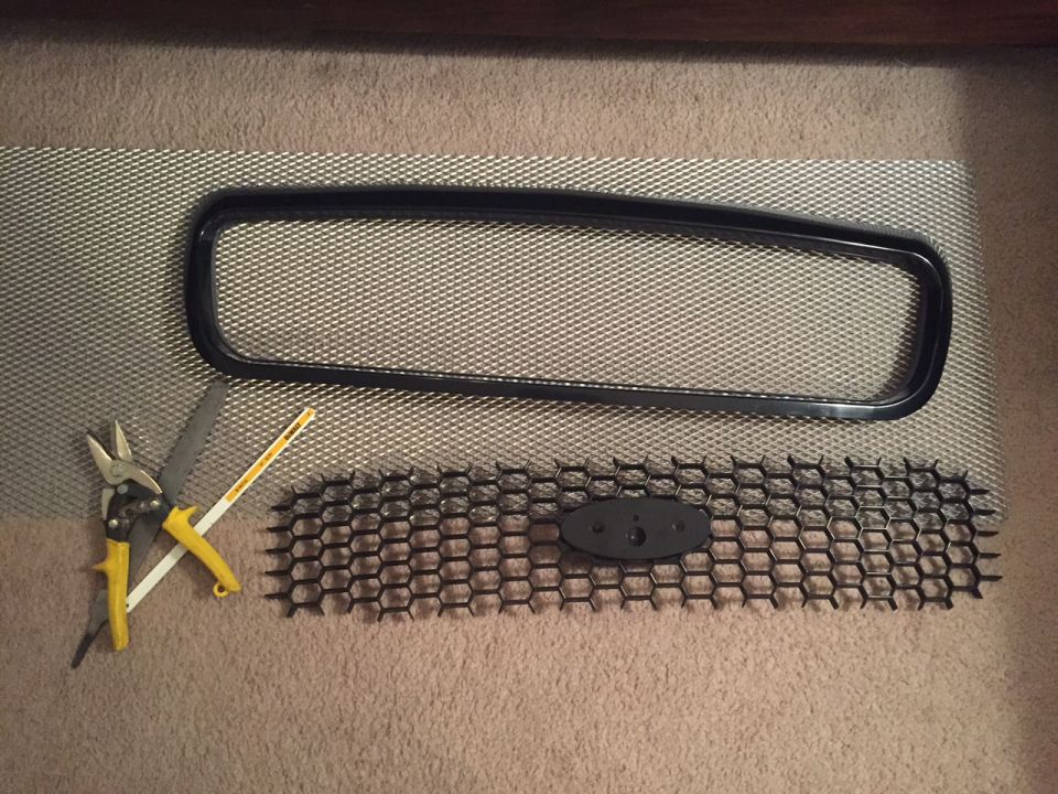 Cut out the honeycomb center of a Police Interceptor grille and sanded down the edges.  Created a smooth straight back side for the mesh to butt up from the back.