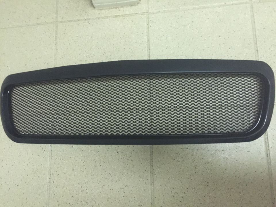 Black aftermarket mesh grille with diamond pattern