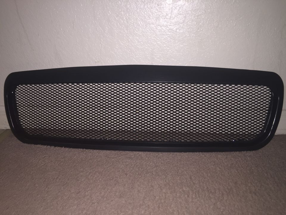 Black aftermarket mesh grille with diamond pattern