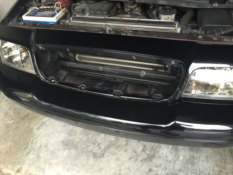 Black Ford Crown Victoria front end with grille removed, showing radiator and transmission cooler.