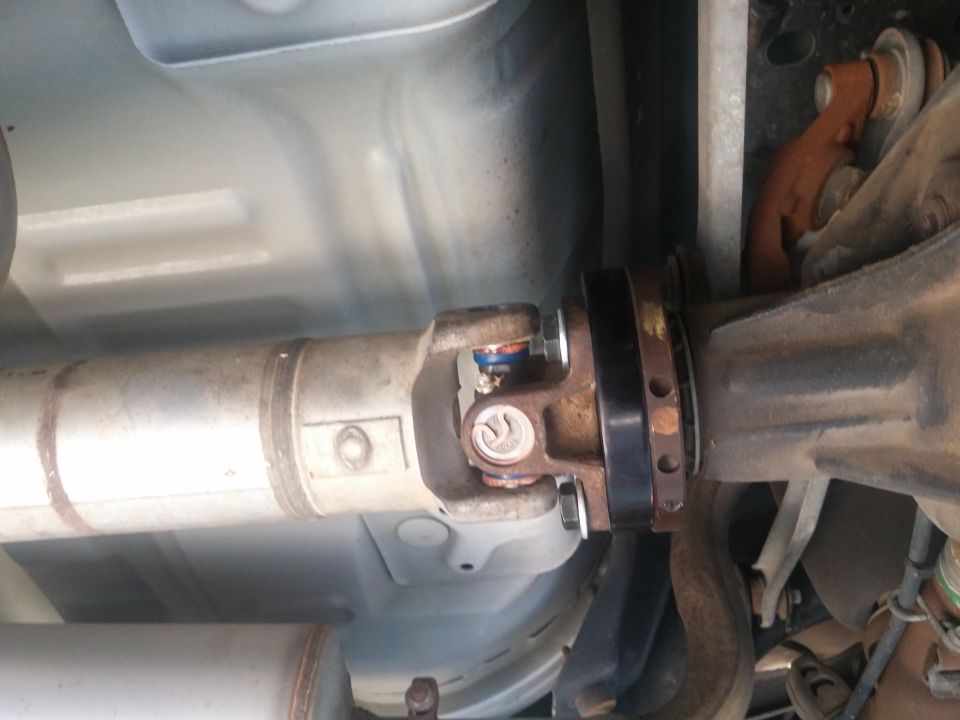 Driveshaft slip yoke and U-joint mounted under a vehicle