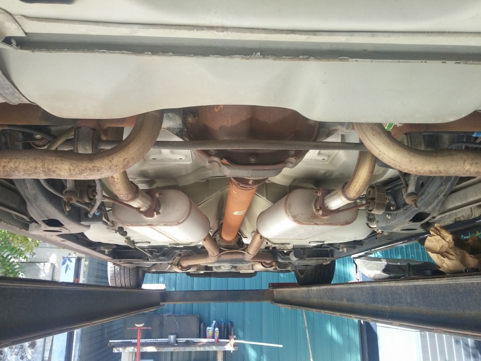 Underside view of a vehicle showing exhaust and rear axle