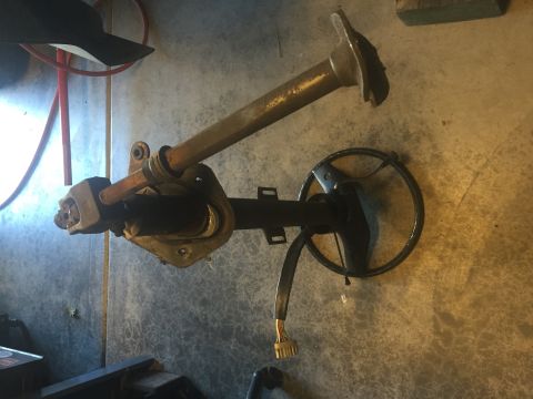 1978 Ford Bronco - This is a close-up, angled shot of a disassembled steering column with a steering wheel attached. A wiring harness with a connector is visi…