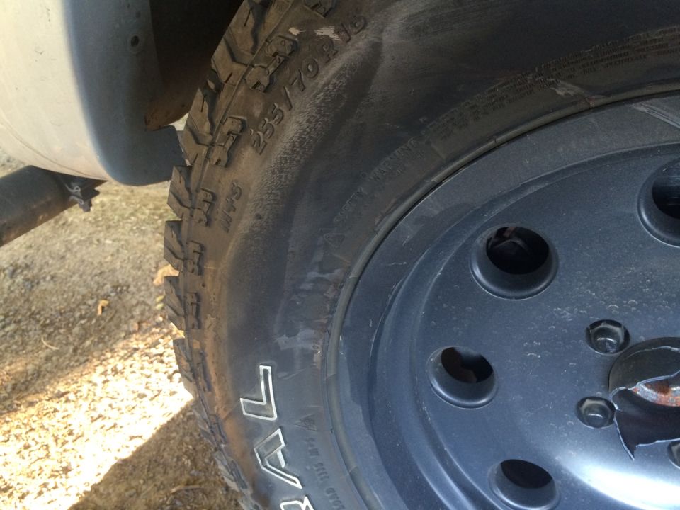 Close-up of a Ford Ranger tire with white lettering and a dark gray wheel.