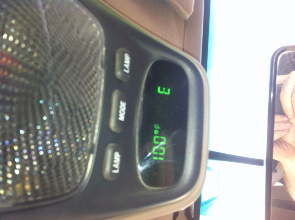 Overhead console with digital display showing 100°F and 3:18 PM, and buttons labeled LAMP and MODE.