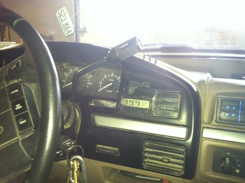 2004 Ford F-250 - The interior of a vehicle is shown, focusing on the dashboard. Visible elements include the steering wheel, instrument cluster with gauges,…