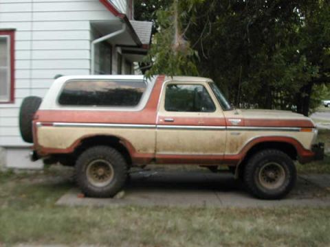 1979 Ford Bronco - This 1979 Ford Bronco is seen from the side, a two-tone paint scheme and a rear-mounted spare tire.