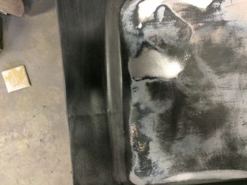 2004 Ford F-250 - A close-up view shows a section of a vehicle's metal surface that has been sanded and prepped for repair or painting. A small square of san…