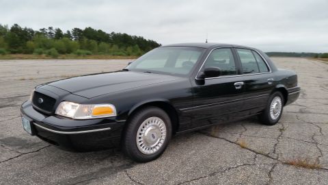 2001 Ford Crown Victoria - Photograph of a black Ford Crown Victoria sedan, not a technical document.