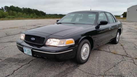 2001 Ford Crown Victoria - Photograph of a black Ford Crown Victoria sedan, not a technical document.
