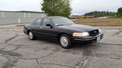 2001 Ford Crown Victoria - 2001 Ford Crown Victoria parked outside a building on an overcast day.