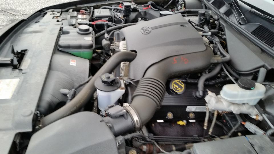 Engine bay of a 2001 Ford Crown Victoria, showing the V8 engine, air intake, and various fluid reservoirs