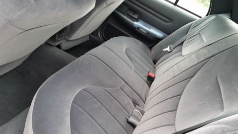 2001 Ford Crown Victoria - The interior of a 2001 Ford Crown Victoria shows gray fabric rear seats and floor.