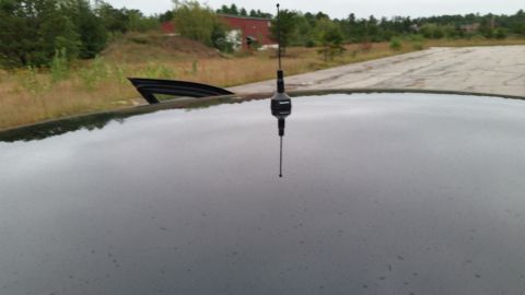 2001 Ford Crown Victoria - View of a car's roof and antenna, with a hint of the surrounding landscape.