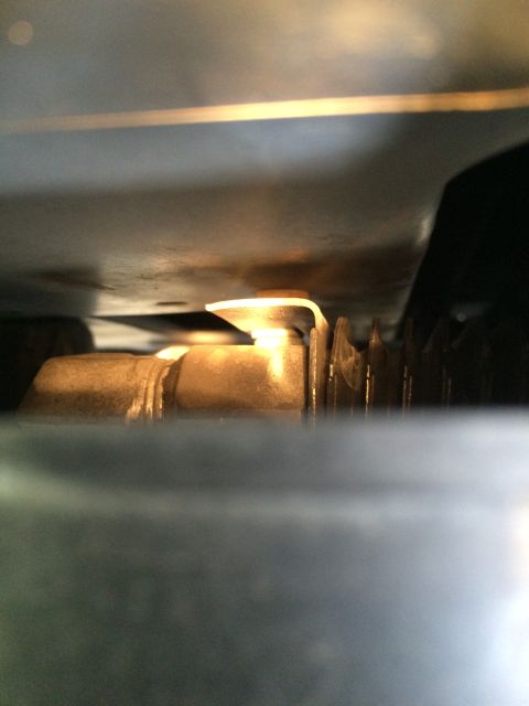 1990 Ford Bronco - Detail of a metal bracket and ribbed component, viewed from a close-up angle.