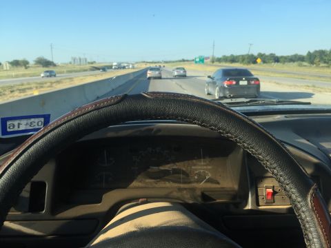 1993 Ford Bronco - Interior view from the driver's seat of a 1993 Ford Bronco on a highway.