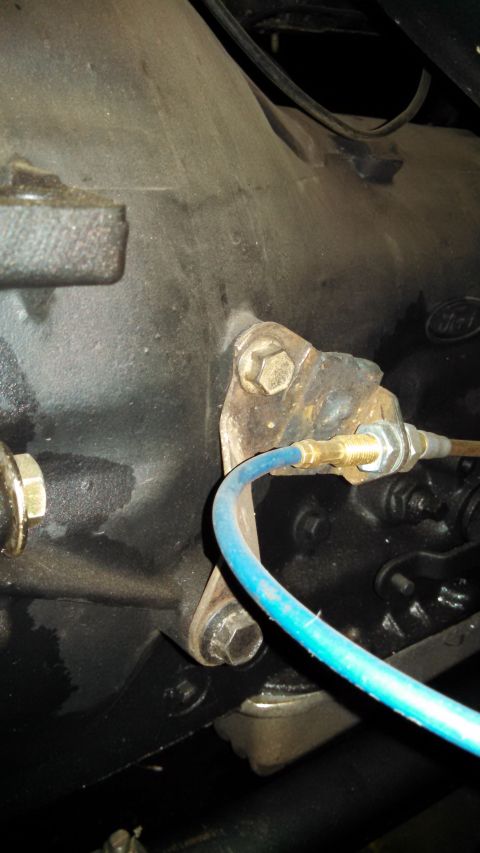 1967 Ford F-250 - Detail of a vehicle's transmission housing and attached blue hose.