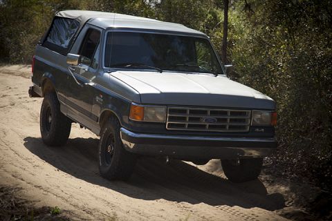 1995 Ford Bronco - This 1995 Ford Bronco is shown in a three-quarter front view on a sandy track.