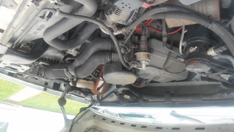 1995 Ford Bronco - The engine bay of a 1995 Ford Bronco, showing the radiator, air intake, and other engine components.
